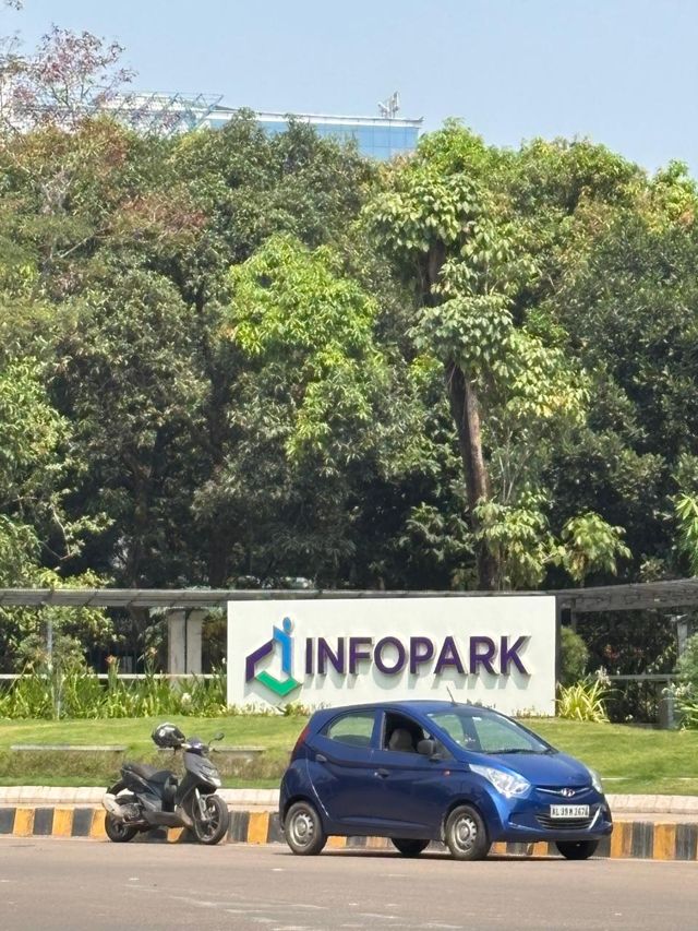 The Infopark sign in front of trees