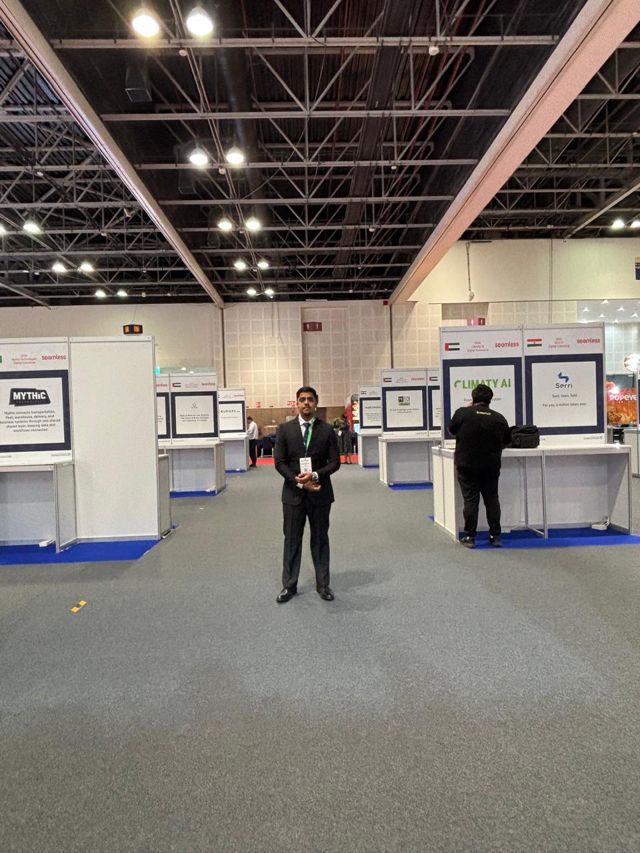 Usman standing in the exhibition hall aisle